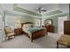 A bedroom with green walls, a ceiling fan, and a wooden bed frame with a light-colored bedspread at 6916 Cameron Glen Dr, Charlotte, NC 28210