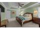 A bedroom with green walls, a ceiling fan, and a wooden bed frame with a light-colored bedspread at 6916 Cameron Glen Dr, Charlotte, NC 28210