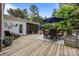 The backyard boasts a deck with an outdoor dining set and seating area, ideal for enjoying the outdoors at 6916 Cameron Glen Dr, Charlotte, NC 28210