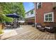 Spacious wooden deck featuring an outdoor dining set, lounge furniture, and a grill, perfect for entertaining guests at 6916 Cameron Glen Dr, Charlotte, NC 28210