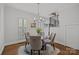 Cozy dining area featuring a glass table, comfortable chairs, and natural light streaming through the plantation shutters at 6916 Cameron Glen Dr, Charlotte, NC 28210