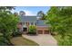 Stately brick home with a manicured lawn and two-car garage at 6916 Cameron Glen Dr, Charlotte, NC 28210