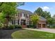 Charming brick home with black shutters, a manicured lawn, and a two-car garage at 6916 Cameron Glen Dr, Charlotte, NC 28210