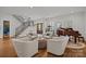 An elegant living room features hardwood floors, neutral-toned furniture, a grand piano, and large windows with shutters at 6916 Cameron Glen Dr, Charlotte, NC 28210
