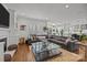Bright living room features a fireplace, built-ins, and a large sectional sofa with a glass coffee table at 6916 Cameron Glen Dr, Charlotte, NC 28210