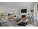 Expansive living room featuring a fireplace, built-ins, and ample seating with a grand piano in the background at 6916 Cameron Glen Dr, Charlotte, NC 28210