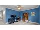 An office space with blue walls, built in shelving, and dual monitors on the desk at 6916 Cameron Glen Dr, Charlotte, NC 28210