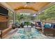 Enjoy the screened-in patio with wood ceiling, tiled floor, brick fireplace, and comfortable seating overlooking the yard at 6916 Cameron Glen Dr, Charlotte, NC 28210