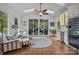 Inviting sun room with vaulted ceilings, skylights, comfortable seating, and a wet bar with wine fridge at 6916 Cameron Glen Dr, Charlotte, NC 28210