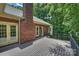 Expansive back deck offering outdoor living space with brick facade and wooded views at 7117 Cobblecreek Dr, Weddington, NC 28104