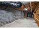Unfinished basement with exposed beams and block walls offering potential for customization at 7117 Cobblecreek Dr, Weddington, NC 28104