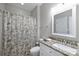 Cozy bathroom features a granite vanity, a floral shower curtain, and ample lighting at 7117 Cobblecreek Dr, Weddington, NC 28104