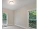 Sunlit bedroom featuring two windows offering a pleasant view of the greenery outside at 7117 Cobblecreek Dr, Weddington, NC 28104