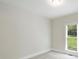 Neutral bedroom with a large window providing natural light and views of the outdoors at 7117 Cobblecreek Dr, Weddington, NC 28104