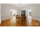 Traditional dining room boasting hardwood floors, chandelier and decorative molding; adjacent to living room at 7117 Cobblecreek Dr, Weddington, NC 28104