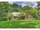 Charming brick home with well-manicured lawn and mature trees offering a serene setting at 7117 Cobblecreek Dr, Weddington, NC 28104