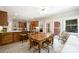 Well-lit eat-in kitchen featuring custom cabinetry, a spacious island, and a view to outdoor scenery at 7117 Cobblecreek Dr, Weddington, NC 28104