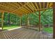 View of the under-deck area with support beams and a glimpse of the wooded backyard at 7117 Cobblecreek Dr, Weddington, NC 28104