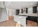 Open concept kitchen features stainless steel appliances, an island and dark cabinets at 716 Flare Dr, Tega Cay, SC 29708