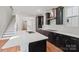 Bright kitchen has a large island, dark cabinets, and stainless steel range hood at 716 Flare Dr, Tega Cay, SC 29708