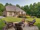 Backyard featuring fire pit, wooden deck, and mature landscaping, perfect for outdoor gatherings at 8101 Cane Pointe Ln, Waxhaw, NC 28173