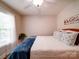 Serene bedroom with natural light, a ceiling fan, comfortable bed, and a charming windowside plant at 8101 Cane Pointe Ln, Waxhaw, NC 28173