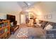 Cozy bonus room with ample seating, built in bookcase, plush carpet, and a ceiling fan at 8101 Cane Pointe Ln, Waxhaw, NC 28173