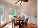 Bright breakfast nook with a dark wood table with windows that let in lots of natural light at 8101 Cane Pointe Ln, Waxhaw, NC 28173