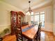 Formal dining room with hardwood flooring, chandelier, china cabinet, and plenty of natural light at 8101 Cane Pointe Ln, Waxhaw, NC 28173
