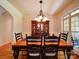 Bright dining room with hardwood flooring, chandelier, and a china cabinet near a bright window at 8101 Cane Pointe Ln, Waxhaw, NC 28173