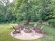 Cozy fire pit surrounded by Adirondack chairs creates a welcoming space for outdoor gatherings at 8101 Cane Pointe Ln, Waxhaw, NC 28173