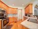 An airy open kitchen with hard wood floors, stainless appliances and granite countertops at 8101 Cane Pointe Ln, Waxhaw, NC 28173