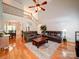 A sprawling living room with high ceilings, wood floors and cozy leather couches at 8101 Cane Pointe Ln, Waxhaw, NC 28173