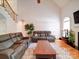 Comfortable living room featuring a soaring ceiling, hardwood floors, and a cozy seating arrangement at 8101 Cane Pointe Ln, Waxhaw, NC 28173