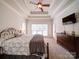 Bright main bedroom with decorative ceiling, carpet, and window, leading to a dresser and closet at 8101 Cane Pointe Ln, Waxhaw, NC 28173