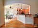 Open concept kitchen, breakfast nook and bar with wood floors and cherry cabinets at 8101 Cane Pointe Ln, Waxhaw, NC 28173