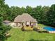 Beautiful backyard featuring an in-ground pool and spacious wooden deck, surrounded by lush greenery and mature trees at 8101 Cane Pointe Ln, Waxhaw, NC 28173