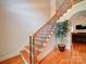 Elegant staircase with wood treads and decorative iron spindles, leading to upper level of home at 8101 Cane Pointe Ln, Waxhaw, NC 28173