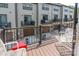 Private outdoor balcony with patio furniture, overlooking the community and garage doors at 819 Anderson St, Charlotte, NC 28205
