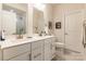 Bright bathroom featuring double sinks with modern fixtures and glass shower enclosure at 819 Anderson St, Charlotte, NC 28205