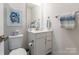 Charming half bathroom featuring toilet, sink, and drawer-lined vanity at 819 Anderson St, Charlotte, NC 28205