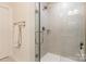 Modern glass shower enclosure with tiled walls and chrome fixtures at 819 Anderson St, Charlotte, NC 28205