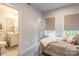 Bright bedroom with ensuite bathroom featuring soft carpet and natural light at 819 Anderson St, Charlotte, NC 28205