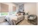 Inviting bedroom featuring soft carpet, natural light, and comfortable reading chair at 819 Anderson St, Charlotte, NC 28205