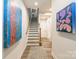 Bright entryway featuring contemporary artwork, a wooden staircase, and neutral tones at 819 Anderson St, Charlotte, NC 28205