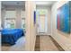 Hallway view with striking artwork leading to a bedroom and an exterior door at 819 Anderson St, Charlotte, NC 28205