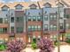 A modern townhome with gray siding, a brick facade, and manicured landscaping at 819 Anderson St, Charlotte, NC 28205