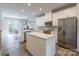 Bright kitchen with white cabinets, a center island, and stainless steel appliances at 819 Anderson St, Charlotte, NC 28205