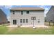 Exterior view of the home's back featuring a basketball hoop and a sliding glass door at 9285 Swimming Dr, Harrisburg, NC 28075