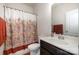 Bathroom with a decorative shower curtain and a sink with dark wood cabinetry at 9285 Swimming Dr, Harrisburg, NC 28075